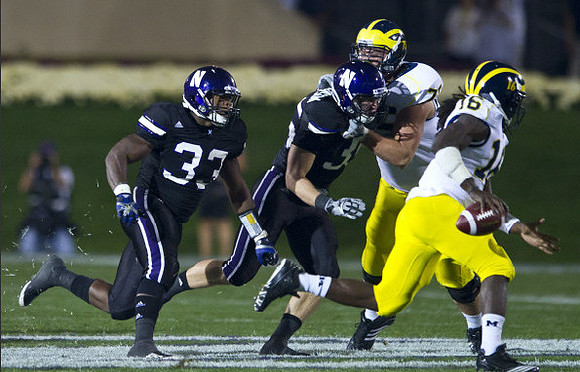 Michael Schofield (75) and Denard Robinson (16)