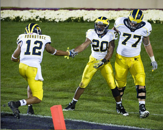 Roy Roundtree (12), Michael Shaw (20), and Taylor Lewan (77)