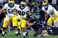 David Molk (50), Fitzgerald Toussaint (28), and Taylor Lewan (77)