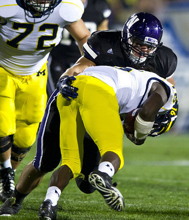 Mark Huyge (72) and Denard Robinson (16)