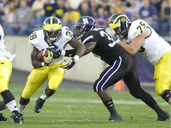 Fitzgerald Toussaint (28) and Michael Schofield (75)