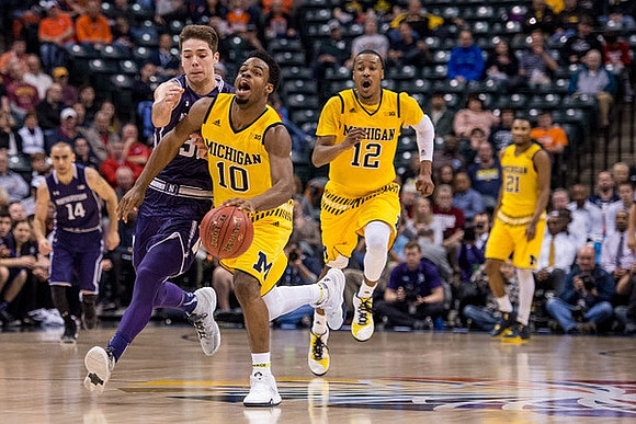 Derrick Walton Jr. (10), Muhammad-Ali Abdur-Rahkman (12), and Zak Irvin (21)