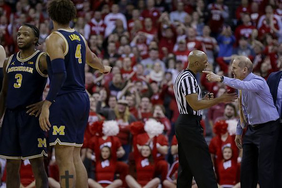 Zavier Simpson (3), Isaiah Livers (4), and John Beilein