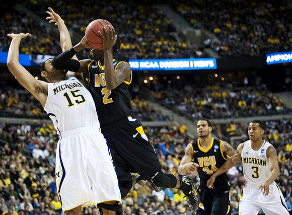 Jon Horford (15) and Trey Burke (3)