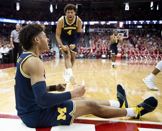 Jordan Poole (2), Isaiah Livers (4), and Zavier Simpson (3)