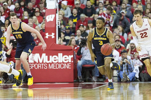 Jon Teske (15) and Zavier Simpson (3)