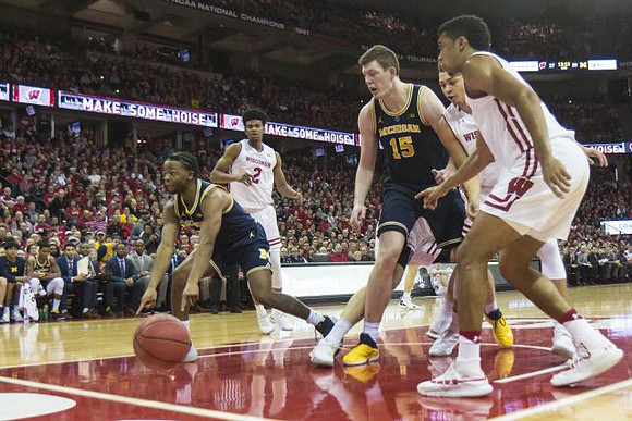 Zavier Simpson (3) and Jon Teske (15)
