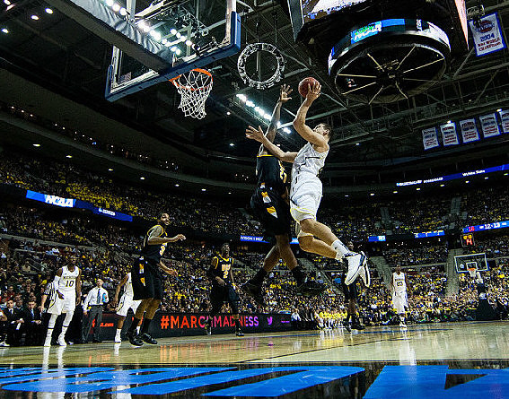 Mitch McGary (4), Tim Hardaway Jr. (10), and Caris LeVert (23)