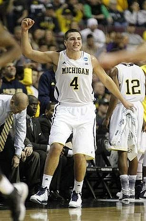 John Beilein, Bacari Alexander, LaVall Jordan, Mitch McGary (4), and Glenn Robinson III (12)