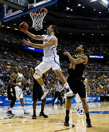 Mitch McGary (4) and Glenn Robinson III (12)
