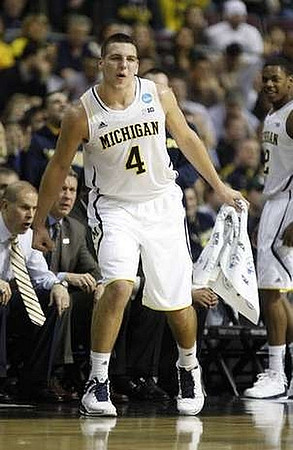 John Beilein, Jeff Meyer, Mitch McGary (4), and Glenn Robinson III (12)