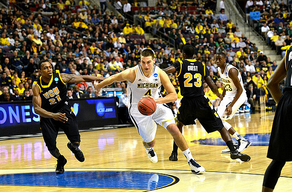 Mitch McGary (4) and Caris LeVert (23)