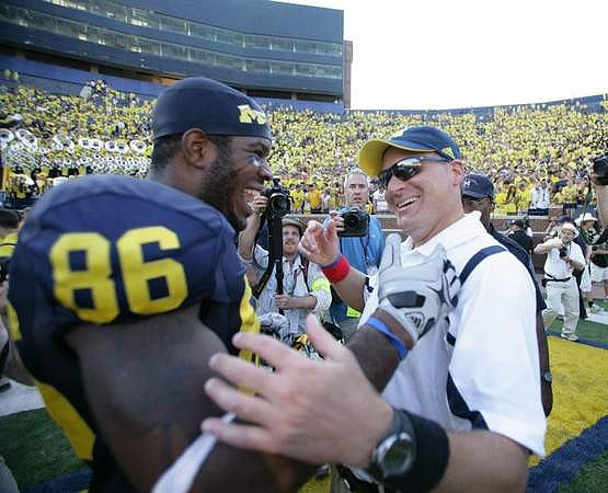 Kevin Koger (86) and Rich Rodriguez
