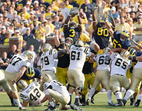 Stevie Brown (3), Martell Webb (80), and Ryan Van Bergen (53)