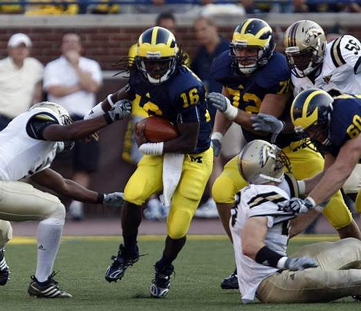 Denard Robinson (16), Mark Huyge (72), and David Moosman (60)