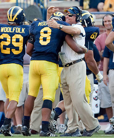 Troy Woolfolk (29), Jonas Mouton (8), Rich Rodriguez, and Mike Martin (68)