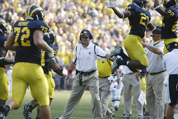 Mark Huyge (72), Junior Hemingway (21), Rich Rodriguez, and Darryl Stonum (22)