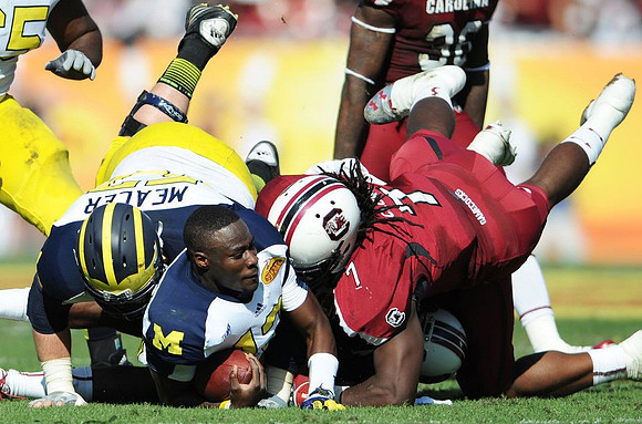 Elliott Mealer (57) and Devin Gardner (12)