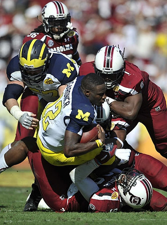 Elliott Mealer (57) and Devin Gardner (12)