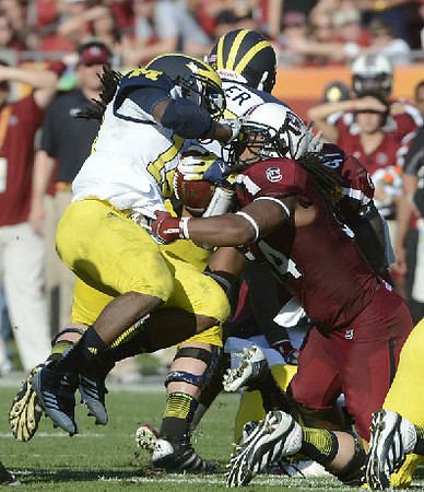 Denard Robinson (16) and Elliott Mealer (57)