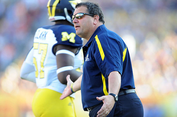 Frank Clark (57) and Brady Hoke