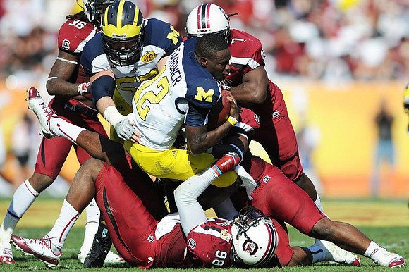 Elliott Mealer (57) and Devin Gardner (12)