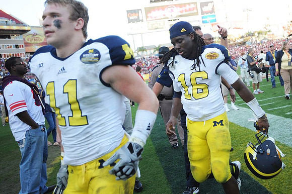Jordan Kovacs (11) and Denard Robinson (16)