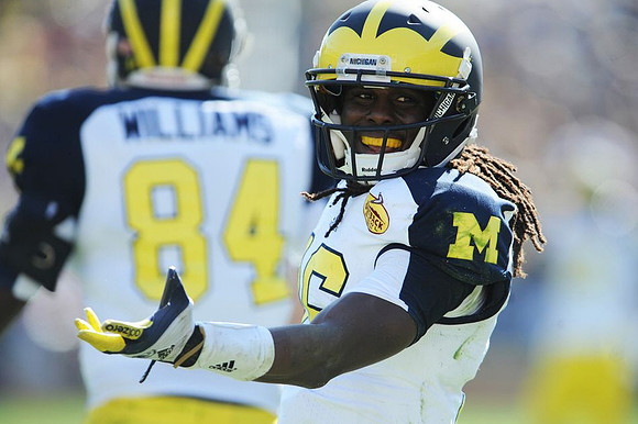 A.J. Williams (84) and Denard Robinson (16)