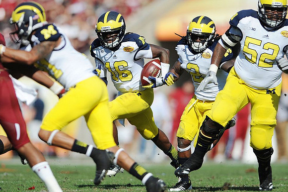 Roy Roundtree (21), Denard Robinson (16), Vincent Smith (2), and Ricky Barnum (52)