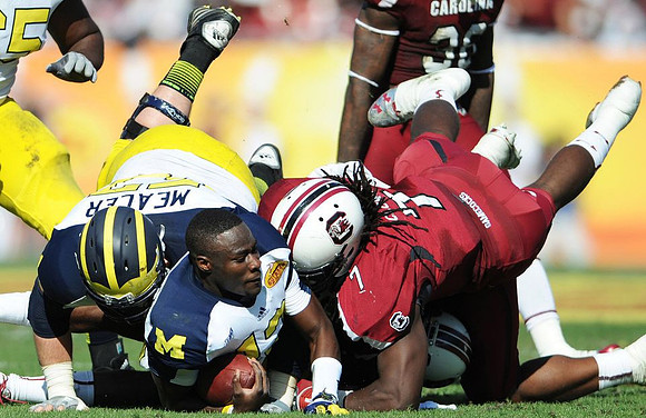 Elliott Mealer (57) and Devin Gardner (12)