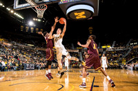 Moritz Wagner (13), Zak Irvin (21), and Derrick Walton Jr. (10)