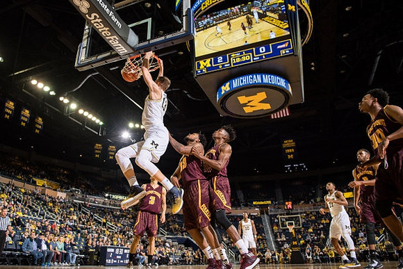 Moritz Wagner (13), Derrick Walton Jr. (10), and Zak Irvin (21)