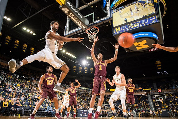 Derrick Walton Jr. (10), D.J. Wilson (5), and Moritz Wagner (13)
