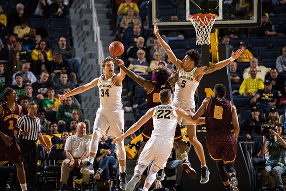 Mark Donnal (34), Duncan Robinson (22), and D.J. Wilson (5)
