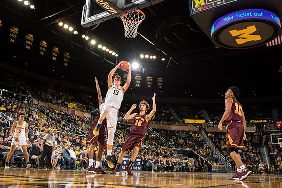 D.J. Wilson (5) and Moritz Wagner (13)