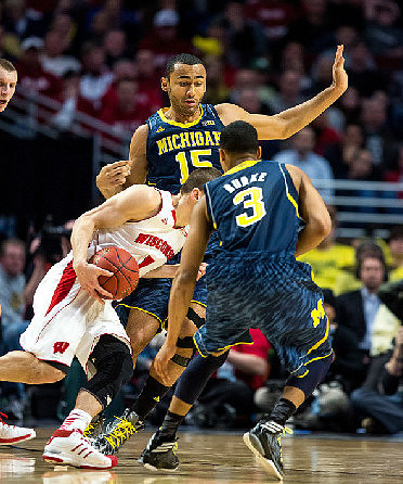 Jon Horford (15) and Trey Burke (3)