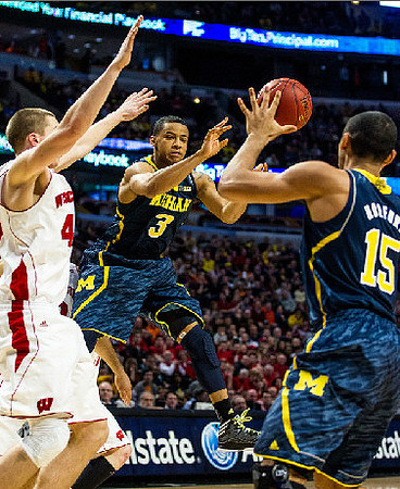 Trey Burke (3) and Jon Horford (15)