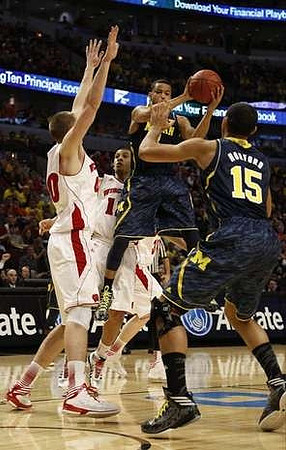 Trey Burke (3) and Jon Horford (15)