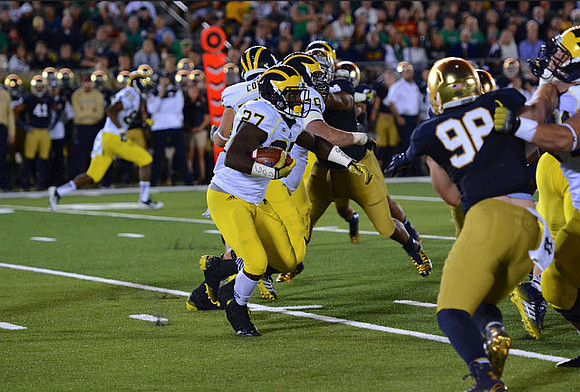 Derrick Green (27), Mason Cole (52), and Erik Magnuson (78)
