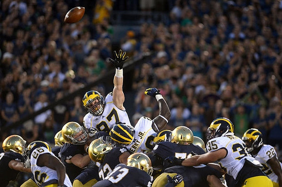 Jourdan Lewis (26), Brennen Beyer (97), Willie Henry (69), Joe Bolden (35), and Jarrod Wilson (22)