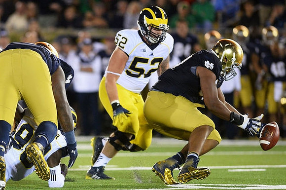 Devin Gardner (98) and Mason Cole (52)