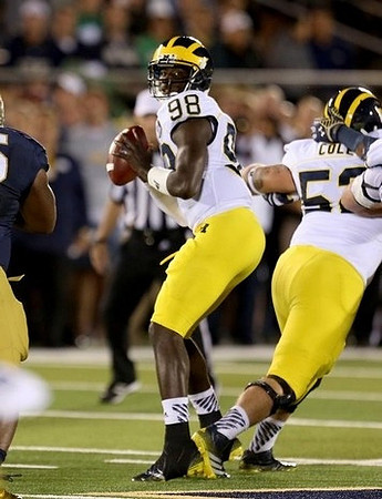 Devin Gardner (98) and Mason Cole (52)