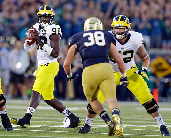 Devin Gardner (98) and Mason Cole (52)