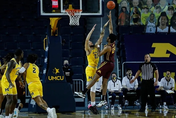 Chaundee Brown Jr. (15), Isaiah Livers (2), and Brandon Johns Jr. (23)