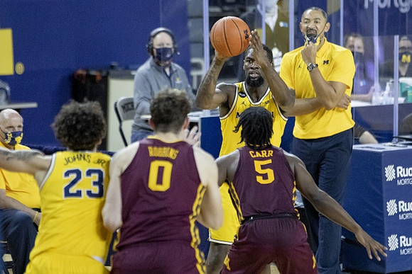 Brandon Johns Jr. (23), Chaundee Brown Jr. (15), and Juwan Howard