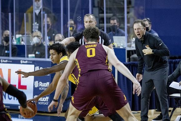Eli Brooks (55) and Minnesota Head Coach Richard Pitino