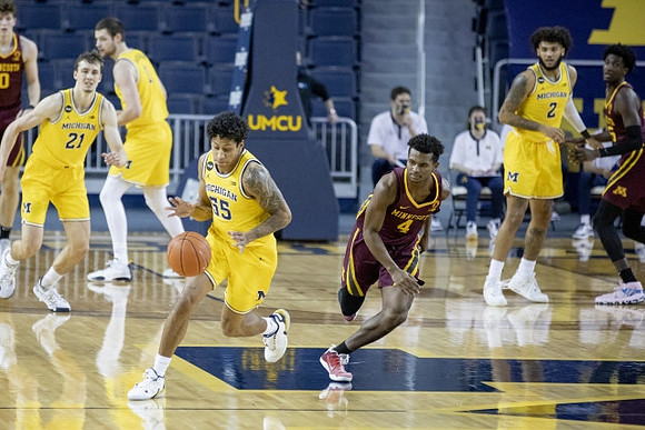 Franz Wagner (21), Hunter Dickinson (1), Eli Brooks (55), and Isaiah Livers (2)