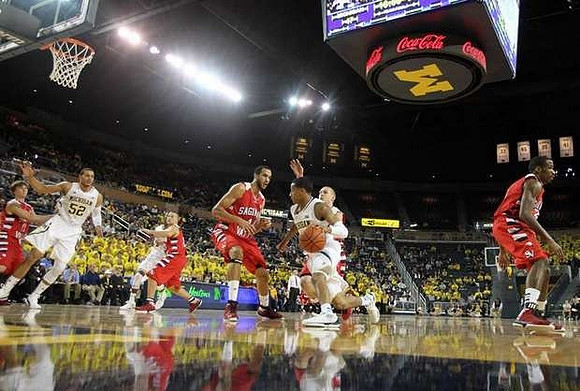 Jordan Morgan (52) and Trey Burke (3)