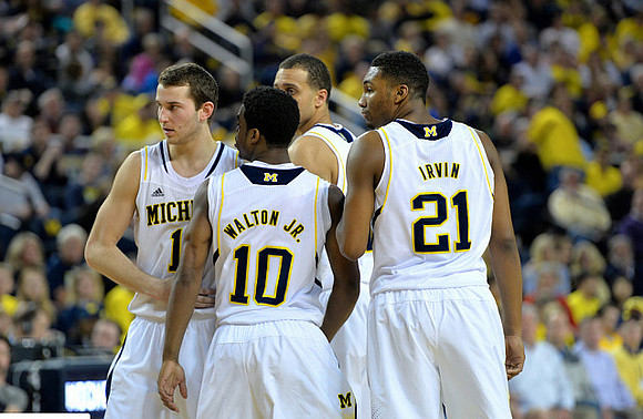 Nik Stauskas (11), Derrick Walton Jr. (10), Jordan Morgan (52), and Zak Irvin (21)