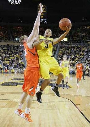 Trey Burke (3) and Blake McLimans (22)